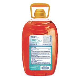 Plastic bottle of orange liquid soap with a yellow cap and handle.