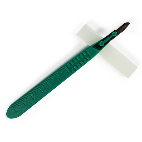 Green-handled scalpel with a sharp blade isolated on white.