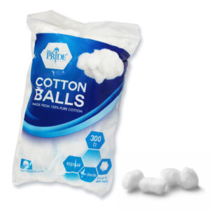 A bag of white cotton balls with a few loose ones beside it.