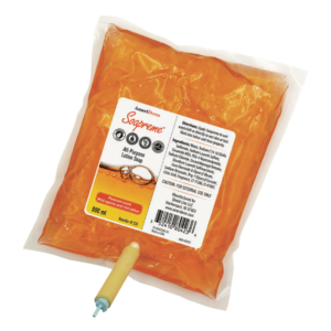 Packaged orange-colored food product with label and nozzle.